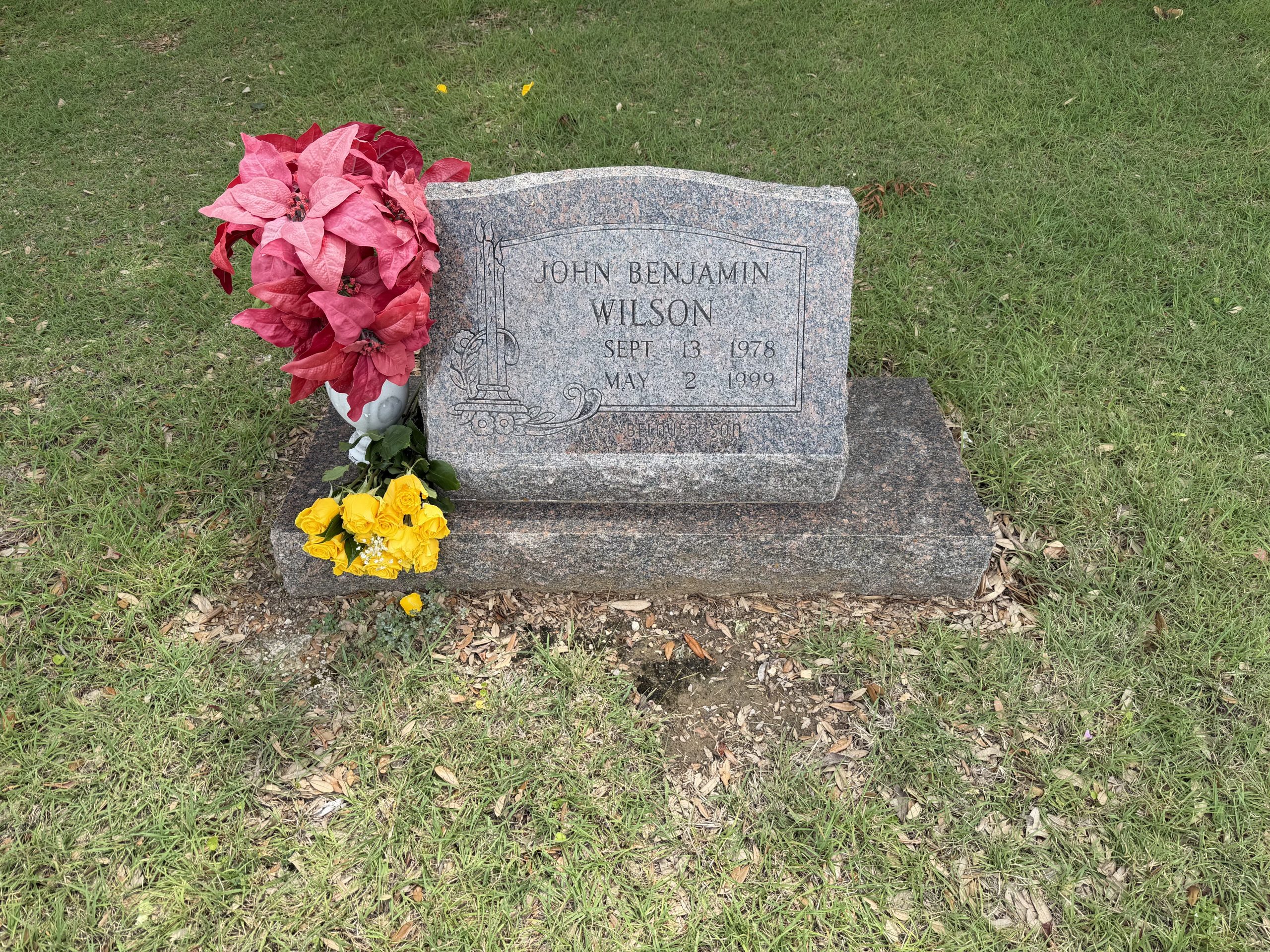 Ben's headstone with yellow roses